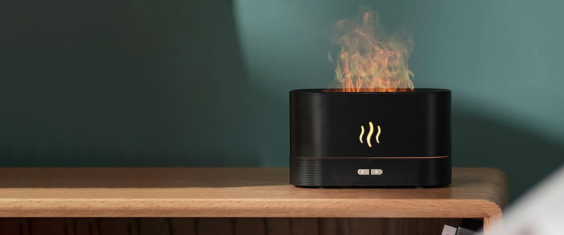 Flame-effect essential oil diffuser and humidifier on a wooden table
